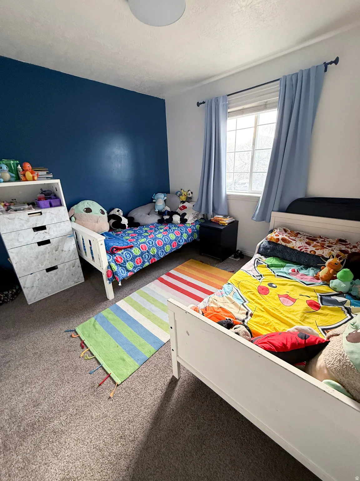 Bedroom with carpet floors and a textured ceiling