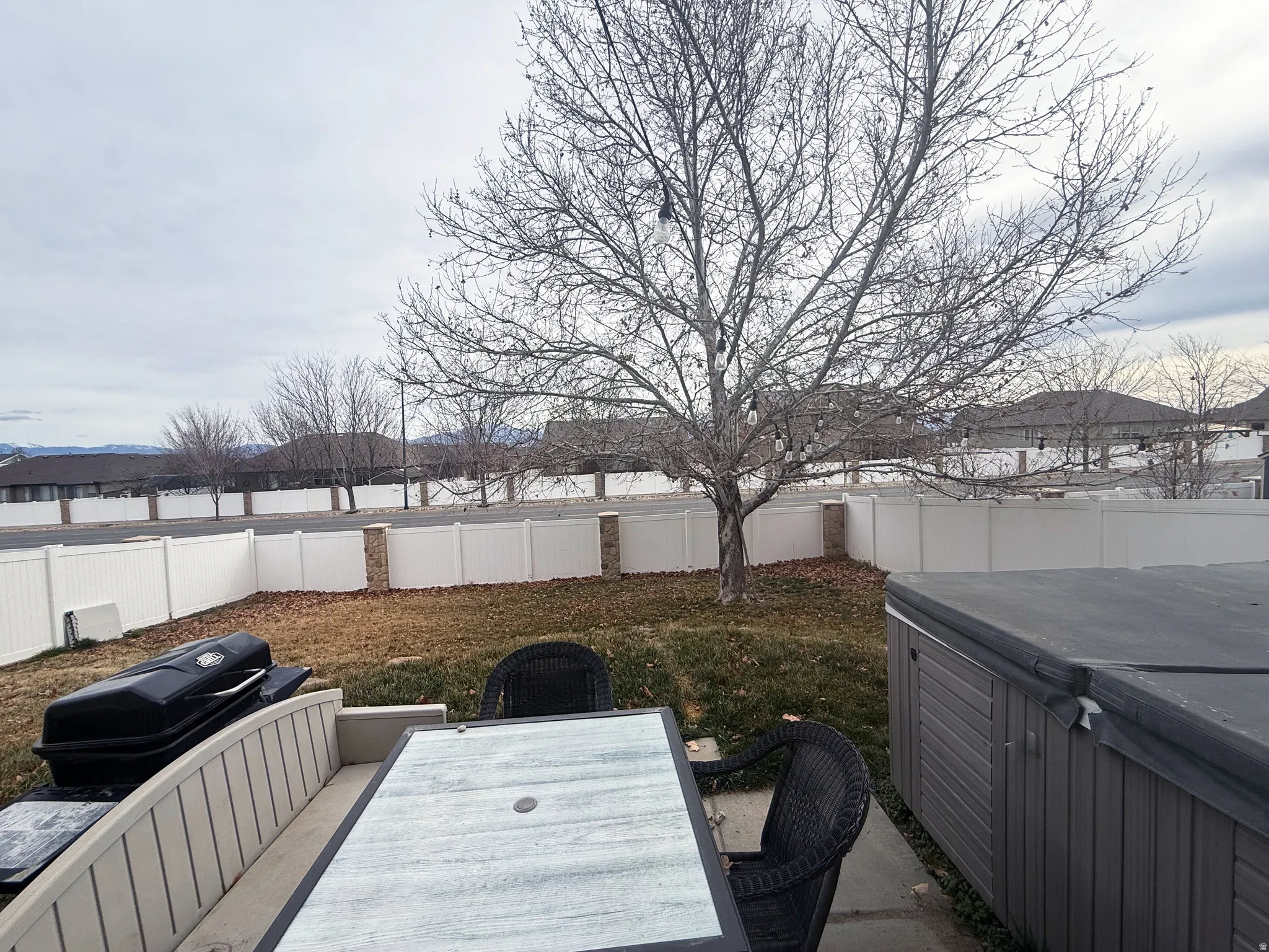 Fenced backyard with outdoor dining space and a patio