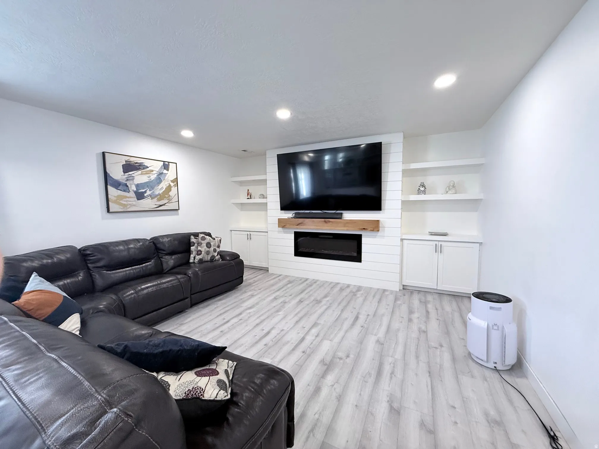 Living area with light wood-type flooring and a large fireplace