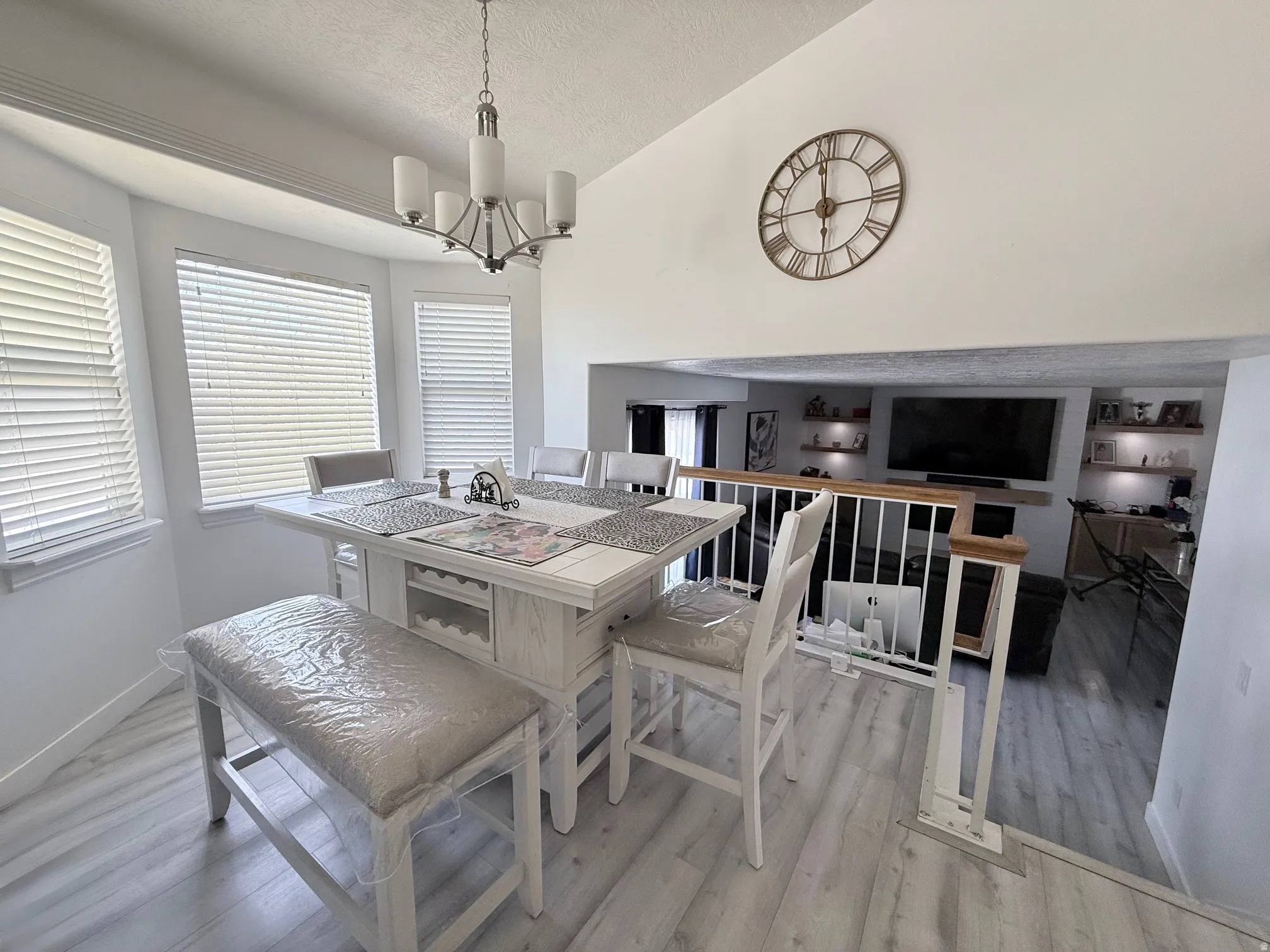 Dining room featuring hanging lights, light wood-style flooring, and healthy amount of natural light