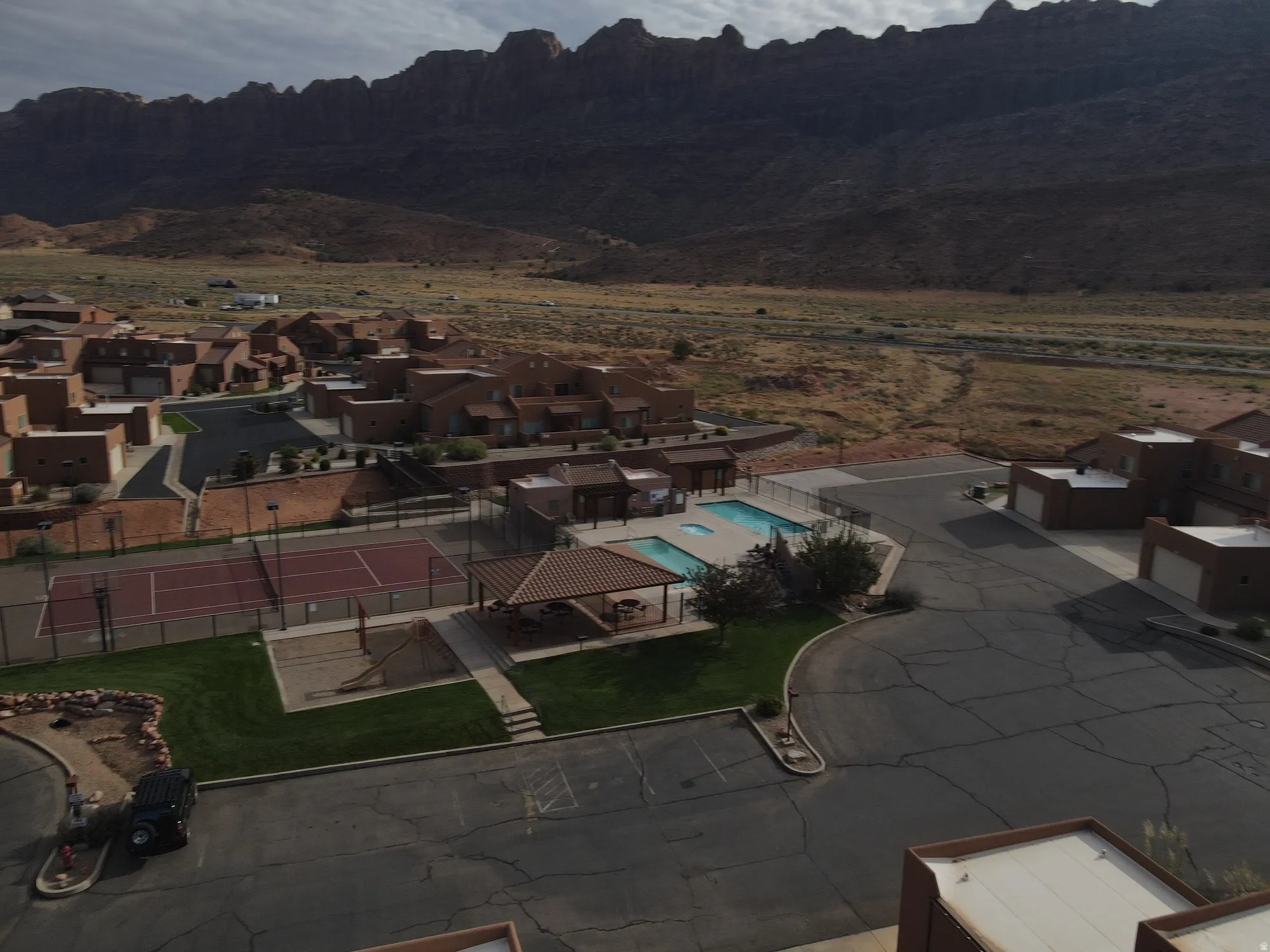 Aerial view of residential area with a pool and mountains