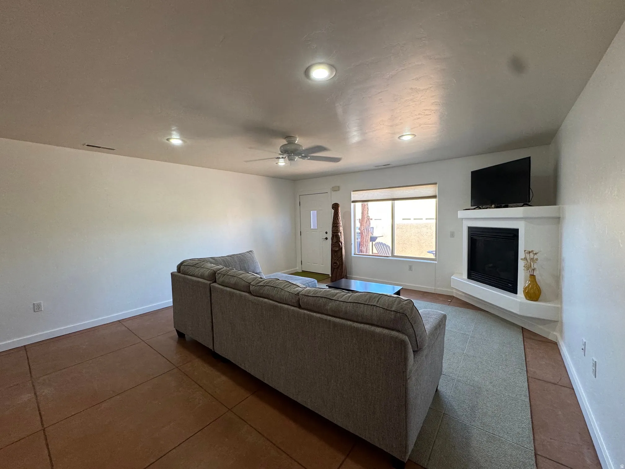 Living space featuring recessed lighting, a ceiling fan, and a built-in corner gas fireplace with a tv mantel
