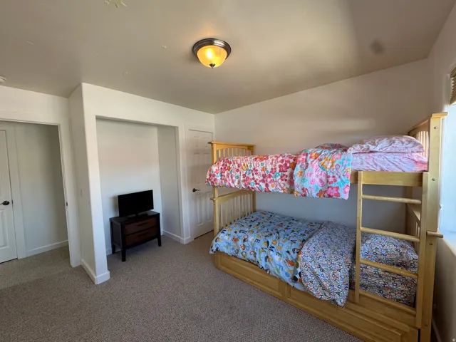 Guest bedroom with bunk beds and mountain views