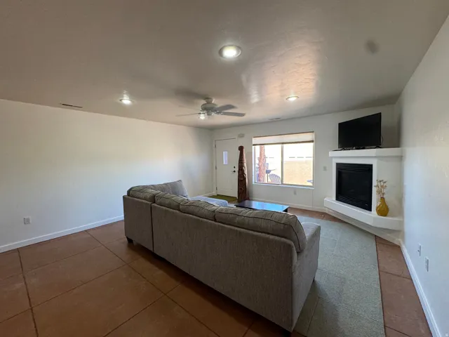 Living space featuring recessed lighting, a ceiling fan, and a built-in corner gas fireplace with a tv mantel