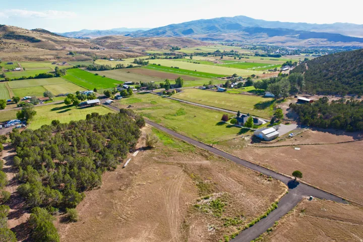 View of property location with rural landscape, a mountainous background, and rows of crops