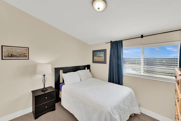Bedroom featuring carpet and lofted ceiling