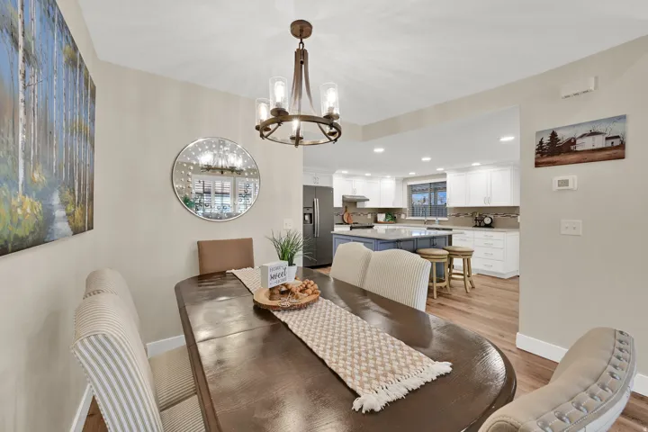 Dining room featuring light wood-style floors, a chandelier, and recessed lighting