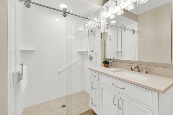 Bathroom featuring vanity and a stall shower