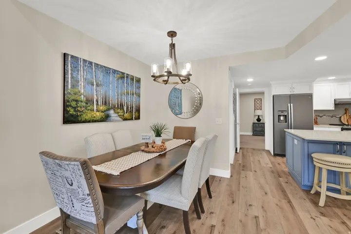 Dining room featuring light wood finished floors, a chandelier, and recessed lighting