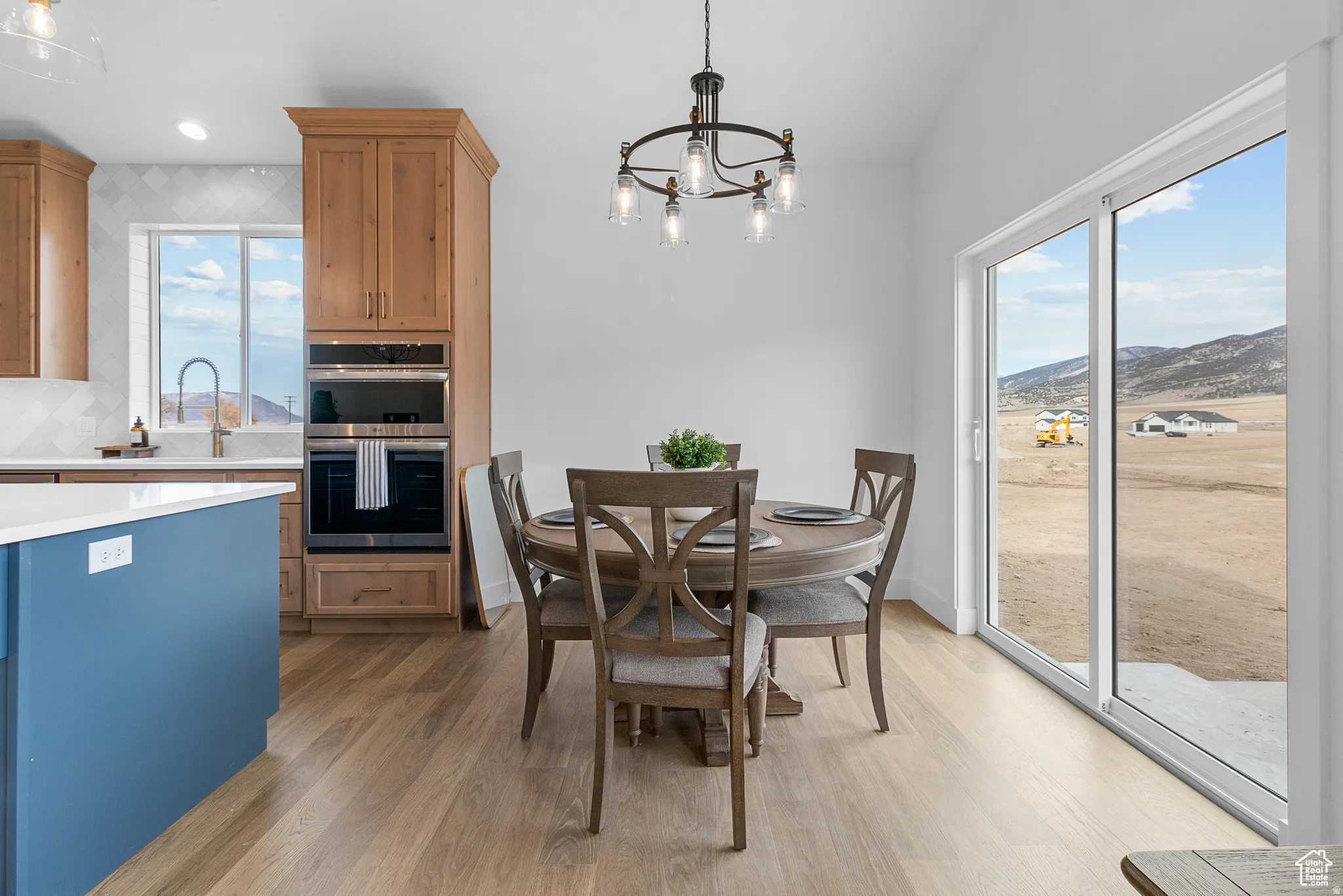 Dining room featuring hanging lights, dark wood-style flooring, and a mountain view