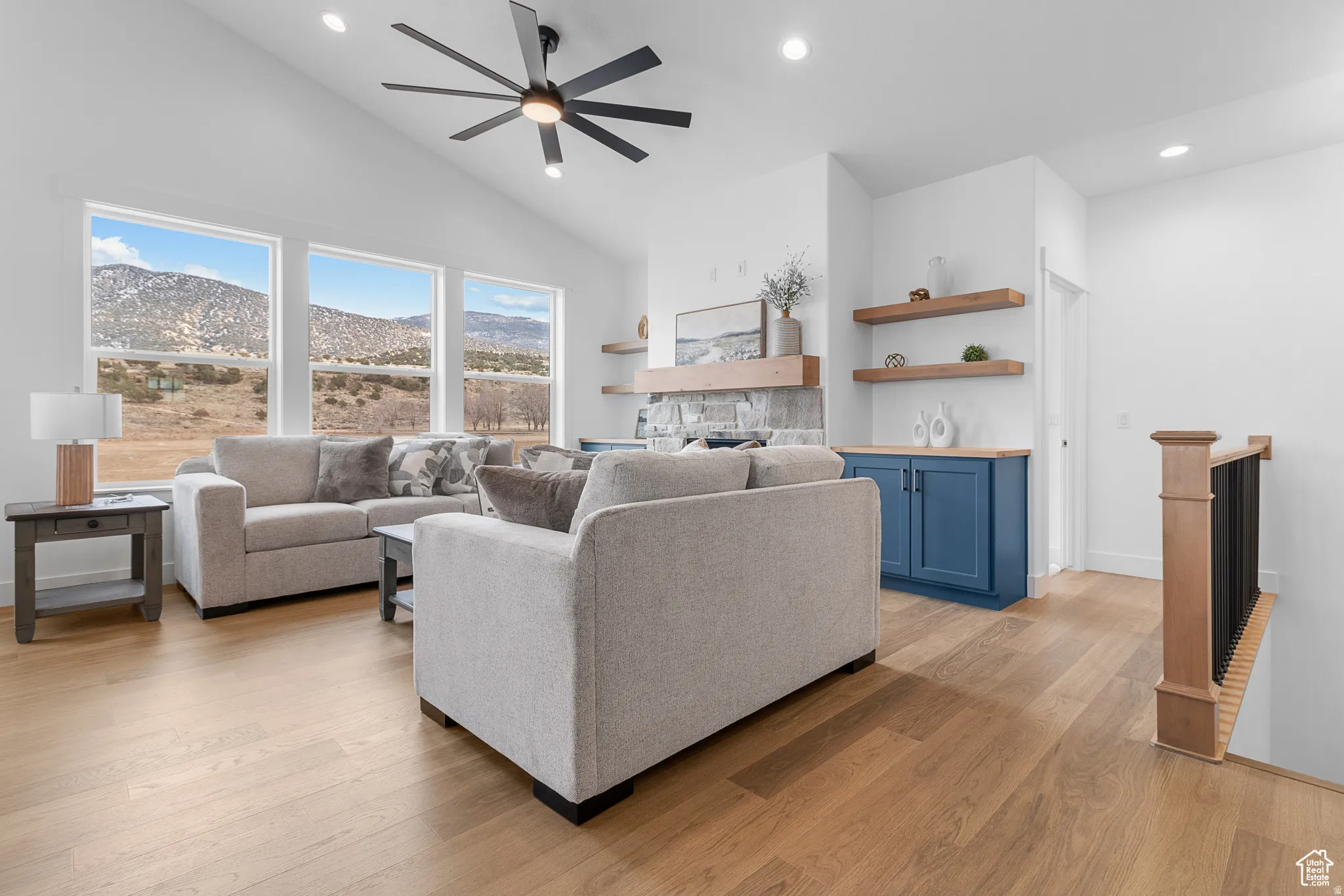 Living area featuring a mountain view, recessed lighting, light wood-style flooring, a ceiling fan, and vaulted ceiling