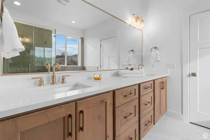 Bathroom featuring double vanity and a stall shower