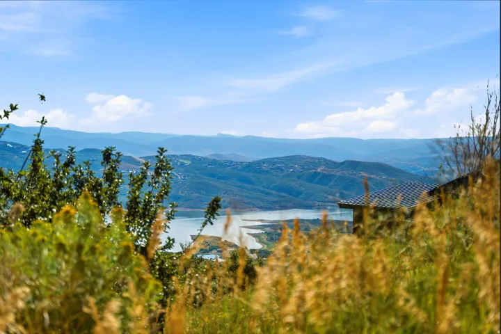 Expansive mountain backdrop with a visible body of water