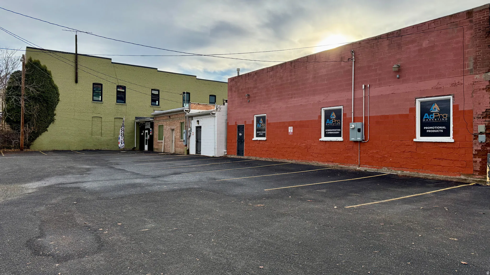 View of building exterior featuring uncovered parking