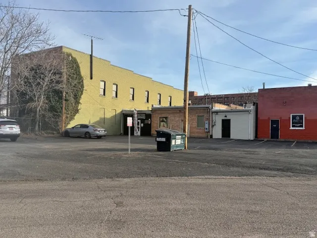 View of building exterior with uncovered parking