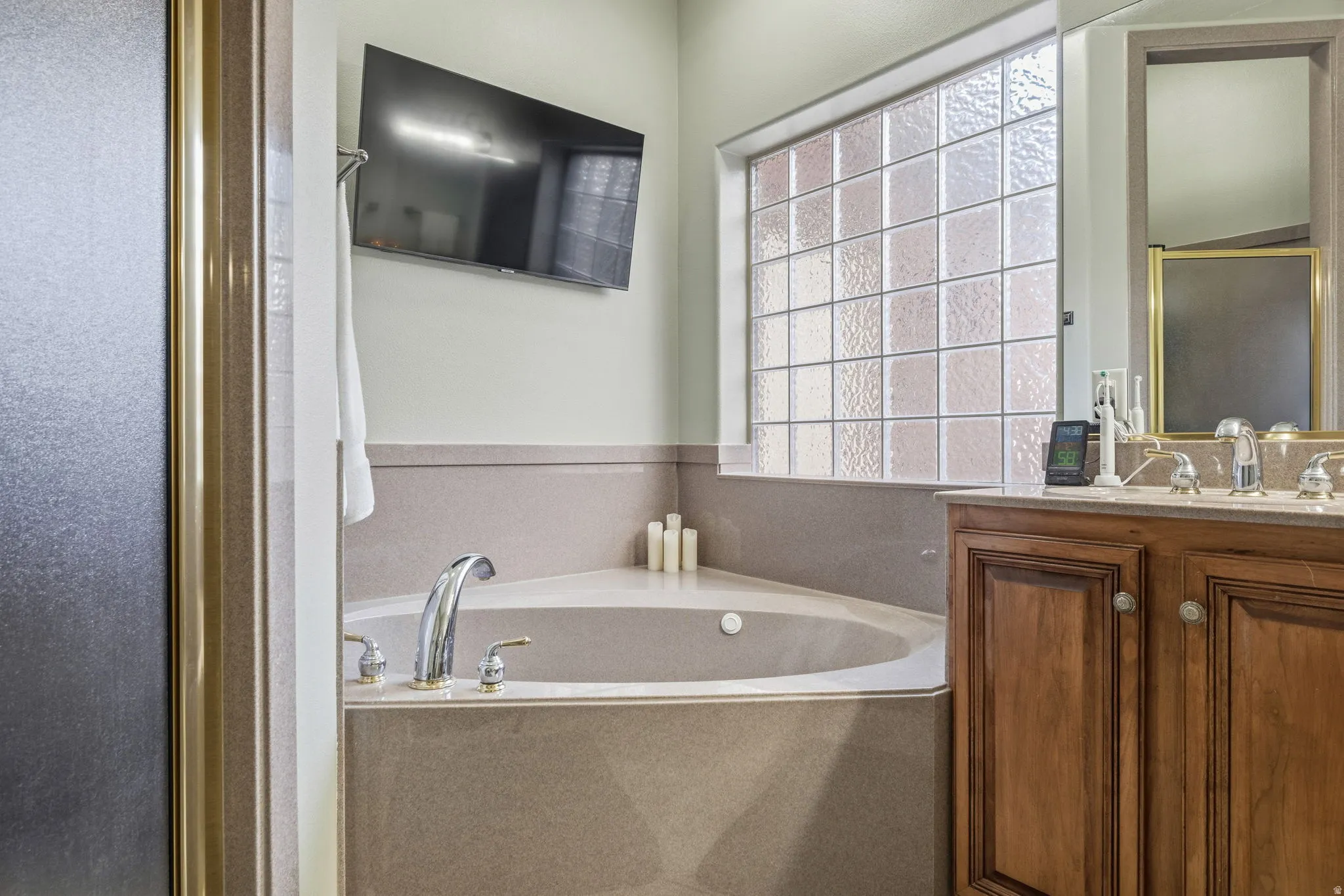 Bathroom with vanity, a garden tub, and a stall shower
