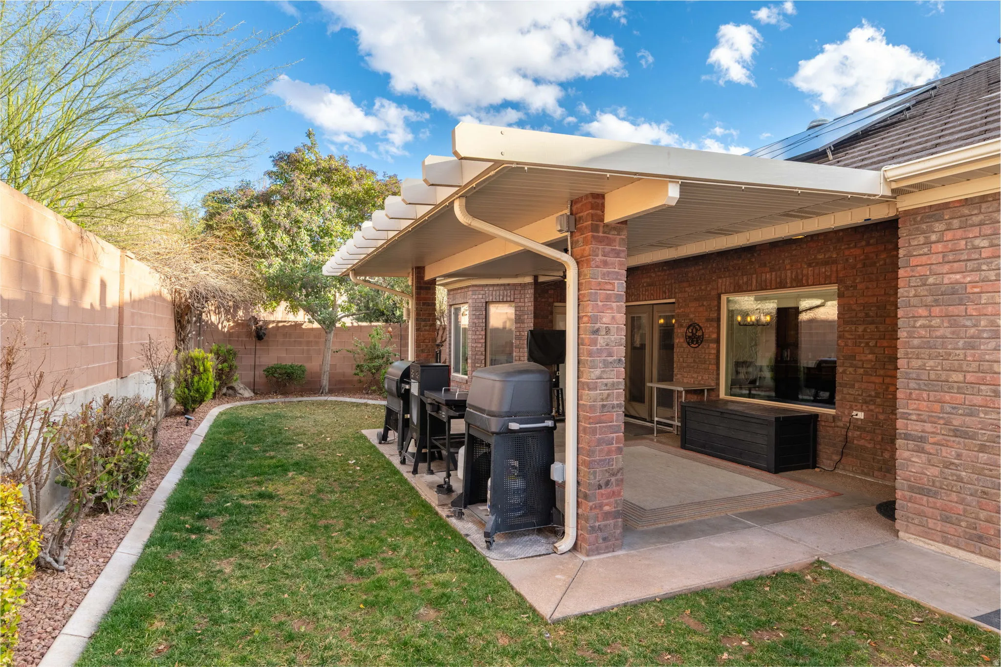 Fenced backyard featuring a patio