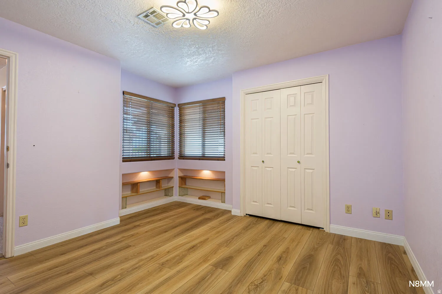 Unfurnished bedroom featuring light wood-style flooring