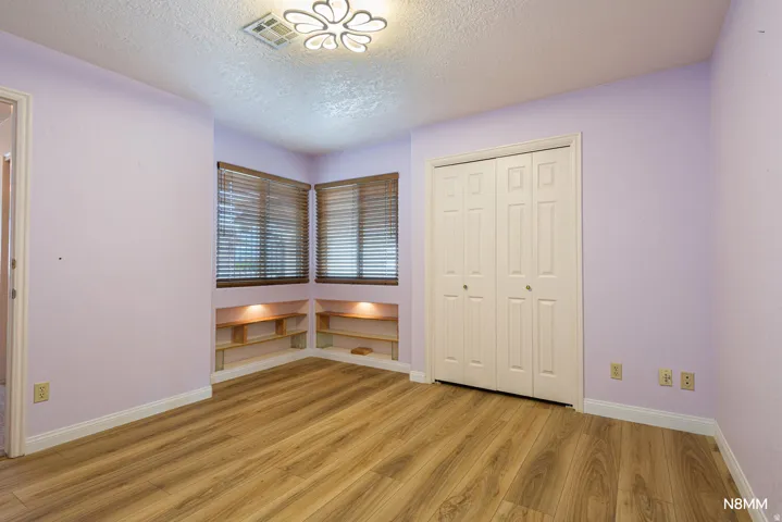Unfurnished bedroom featuring light wood-style flooring