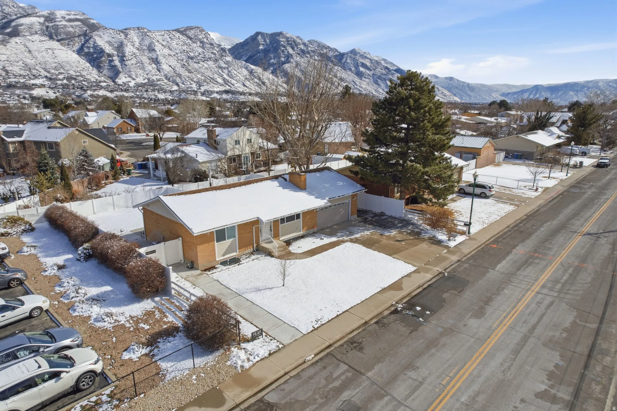 Snowy aerial view with a residential view and a mountain view