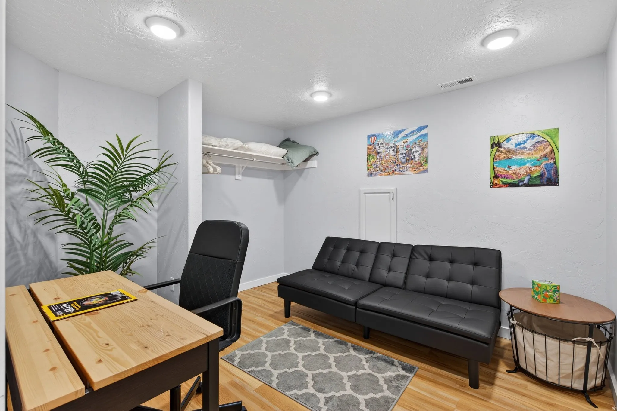 Office featuring a textured ceiling and light wood finished floors
