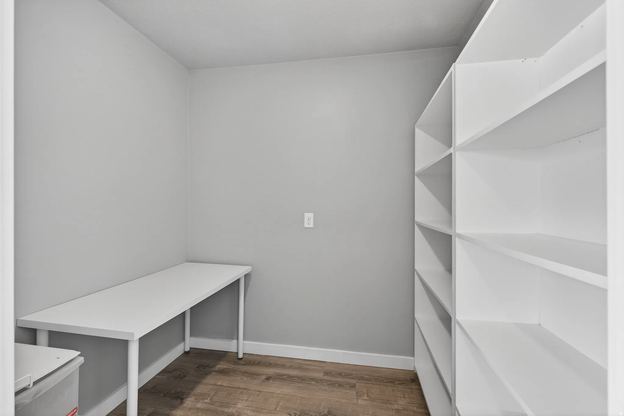 Mudroom with dark wood-type flooring and baseboards
