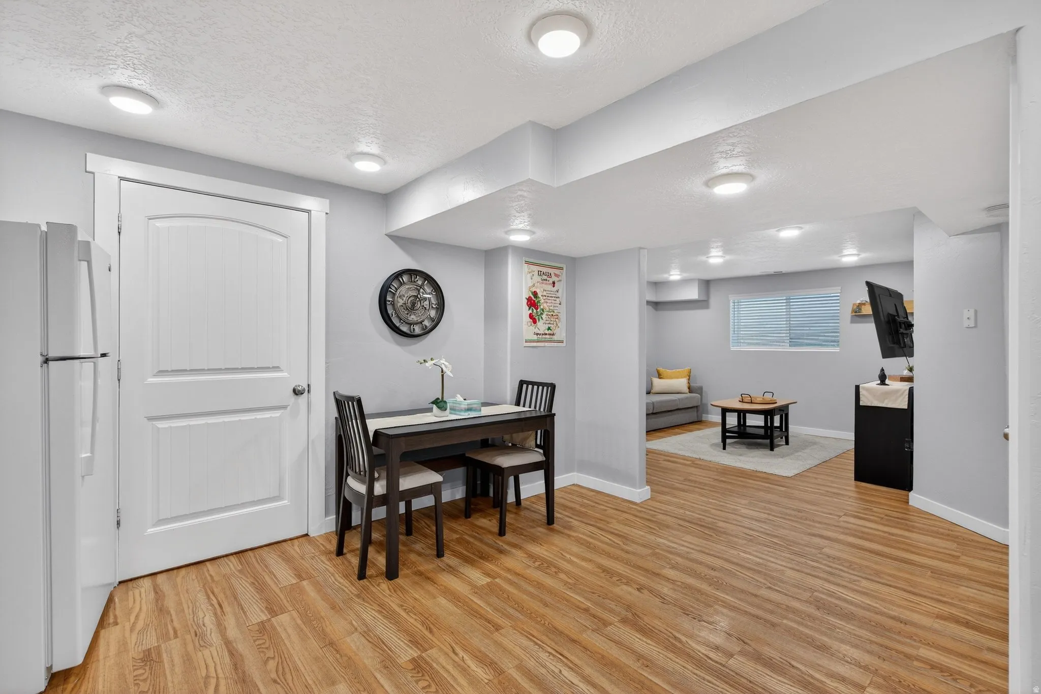 Dining space featuring a textured ceiling and light wood-style flooring