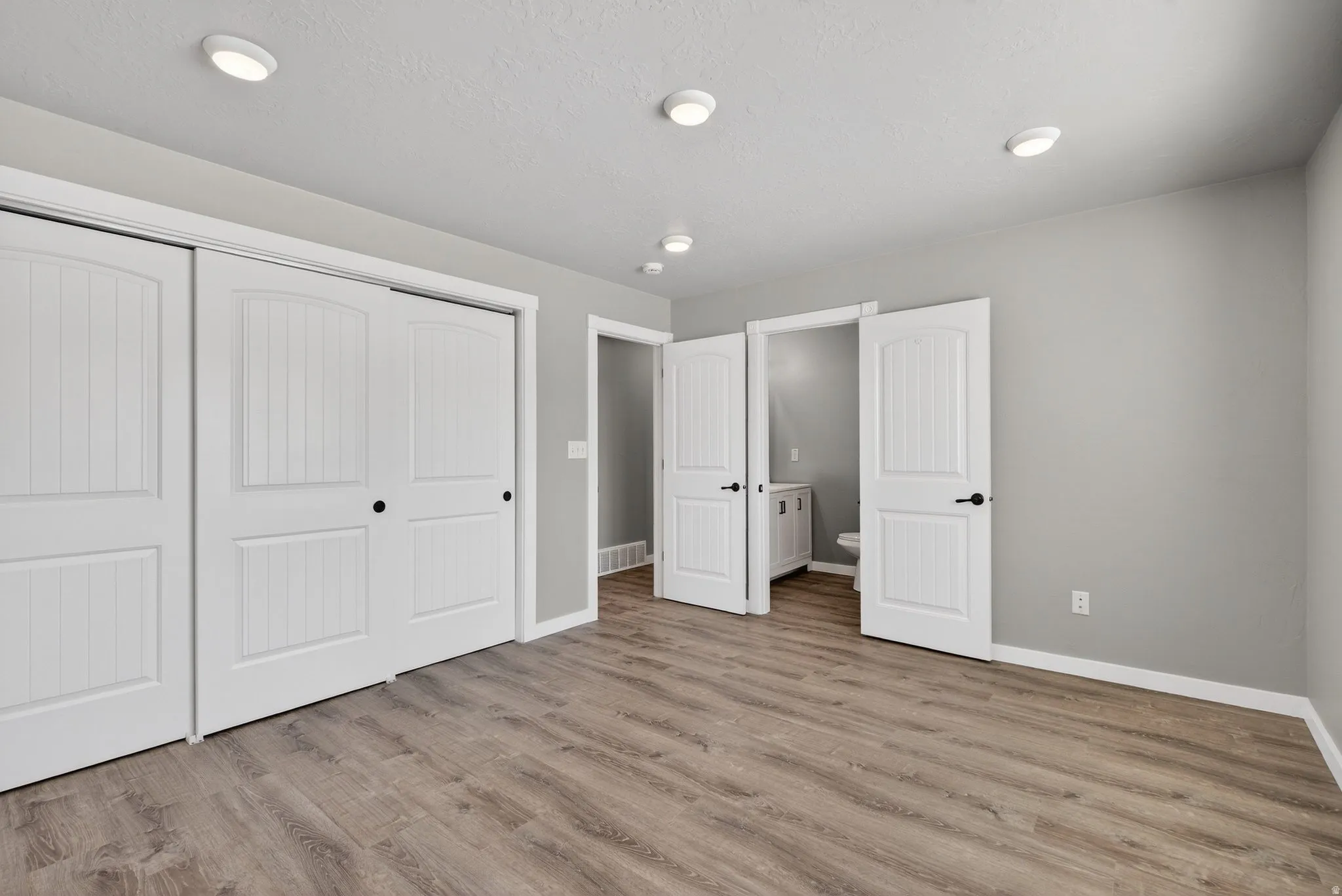 Unfurnished bedroom featuring a closet and light wood-style floors