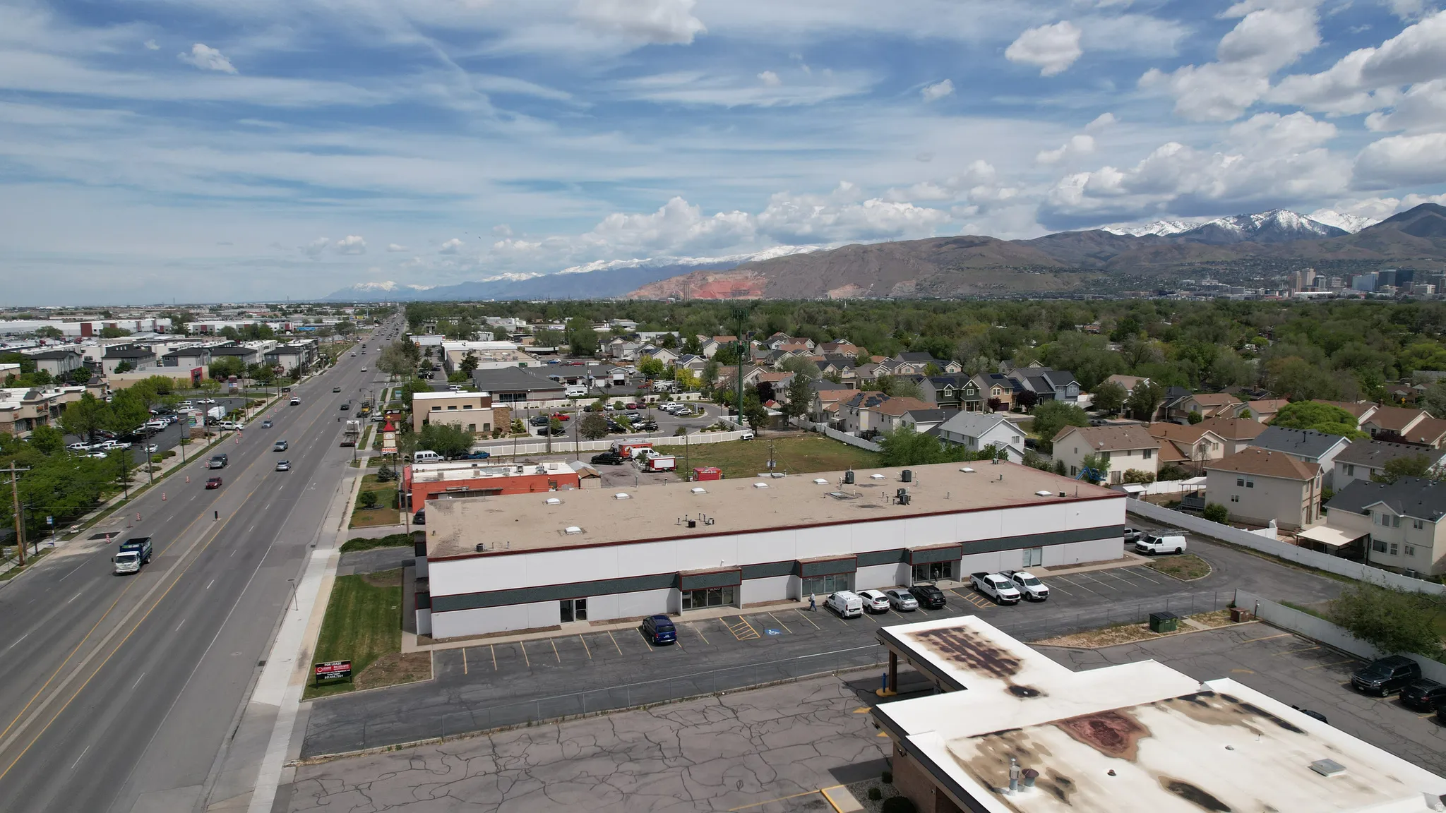 Commercial building featuring a flat roof and ample parking