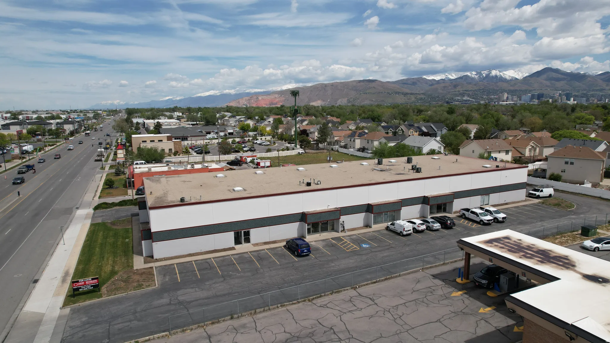 Spacious commercial building featuring a large parking lot, multiple entry points, and a prominent roadside presence