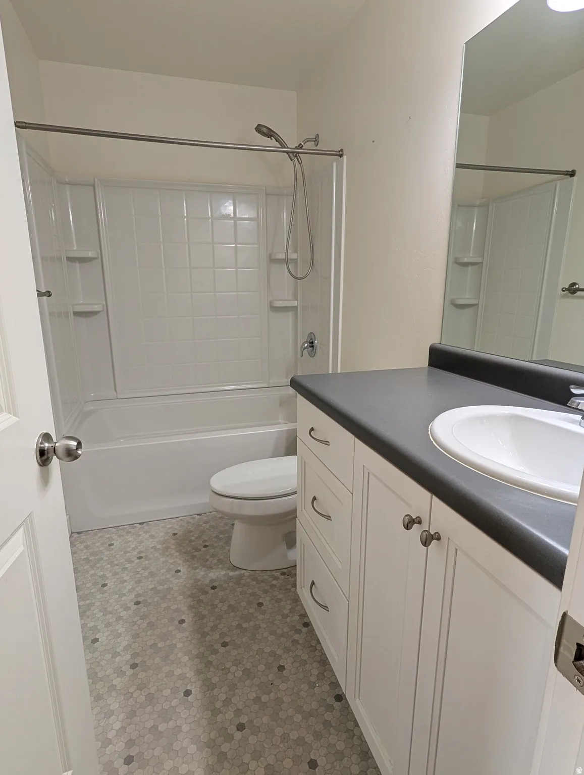 Bathroom featuring vanity,  shower combination, and light flooring