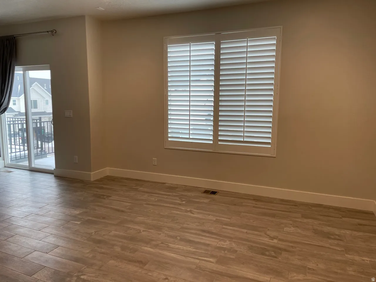 Spare room featuring wood finished floors and plenty of natural light