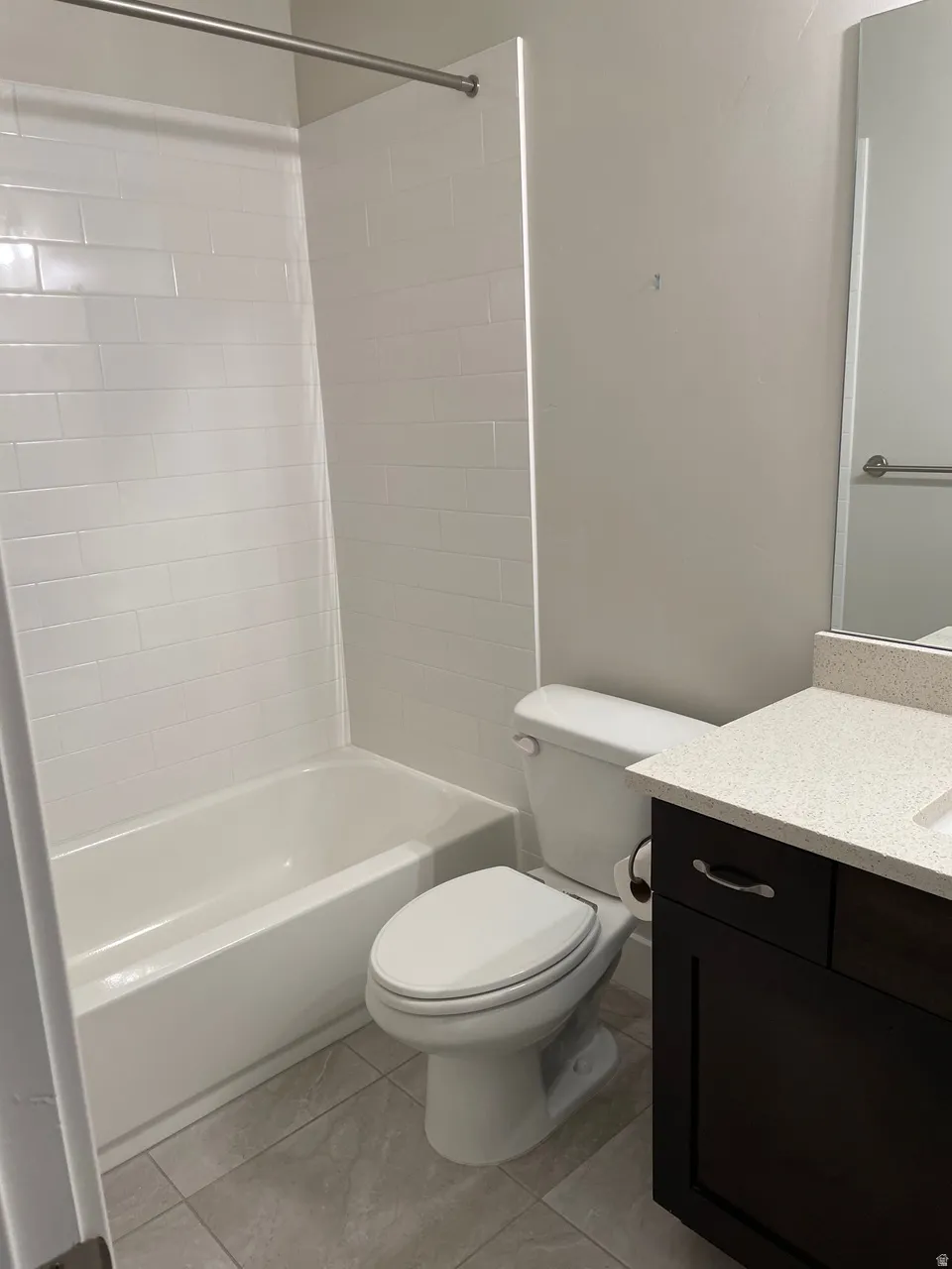 Bathroom featuring vanity and  shower combination