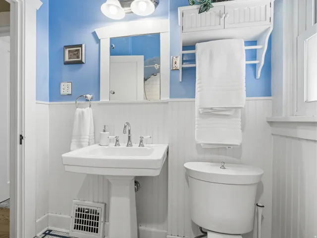 Bathroom with toilet and wainscoting