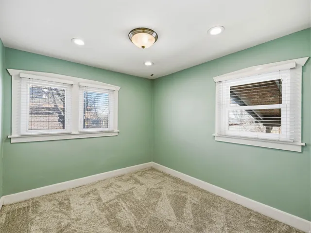 Empty room featuring carpet floors and recessed lighting
