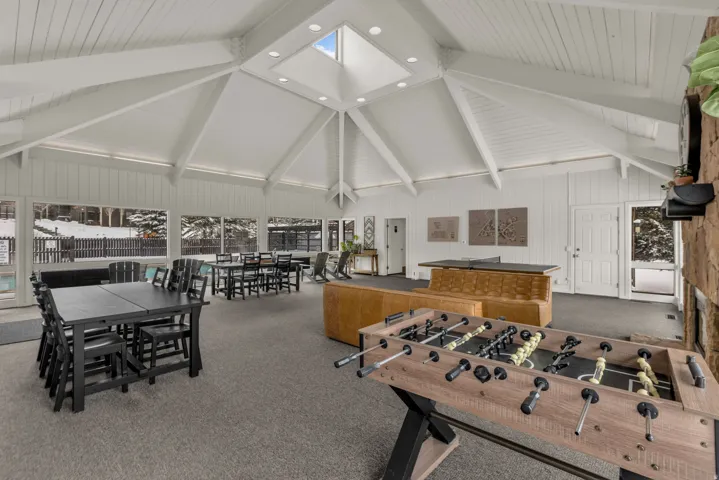 Recreation room with recessed lighting and lofted ceiling