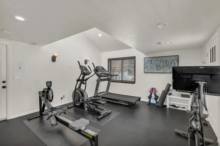 Workout room with a textured ceiling and recessed lighting