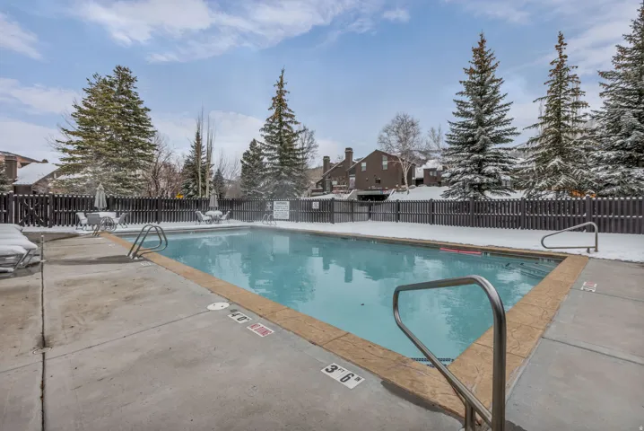 Community pool with a patio