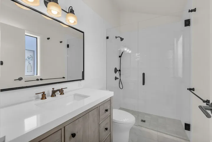 Full bath featuring vanity and a stall shower