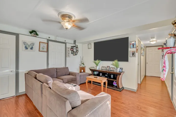 Living room featuring light wood-style flooring and ceiling fan