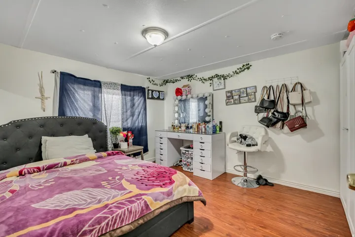 Bedroom featuring light wood finished floors and baseboards