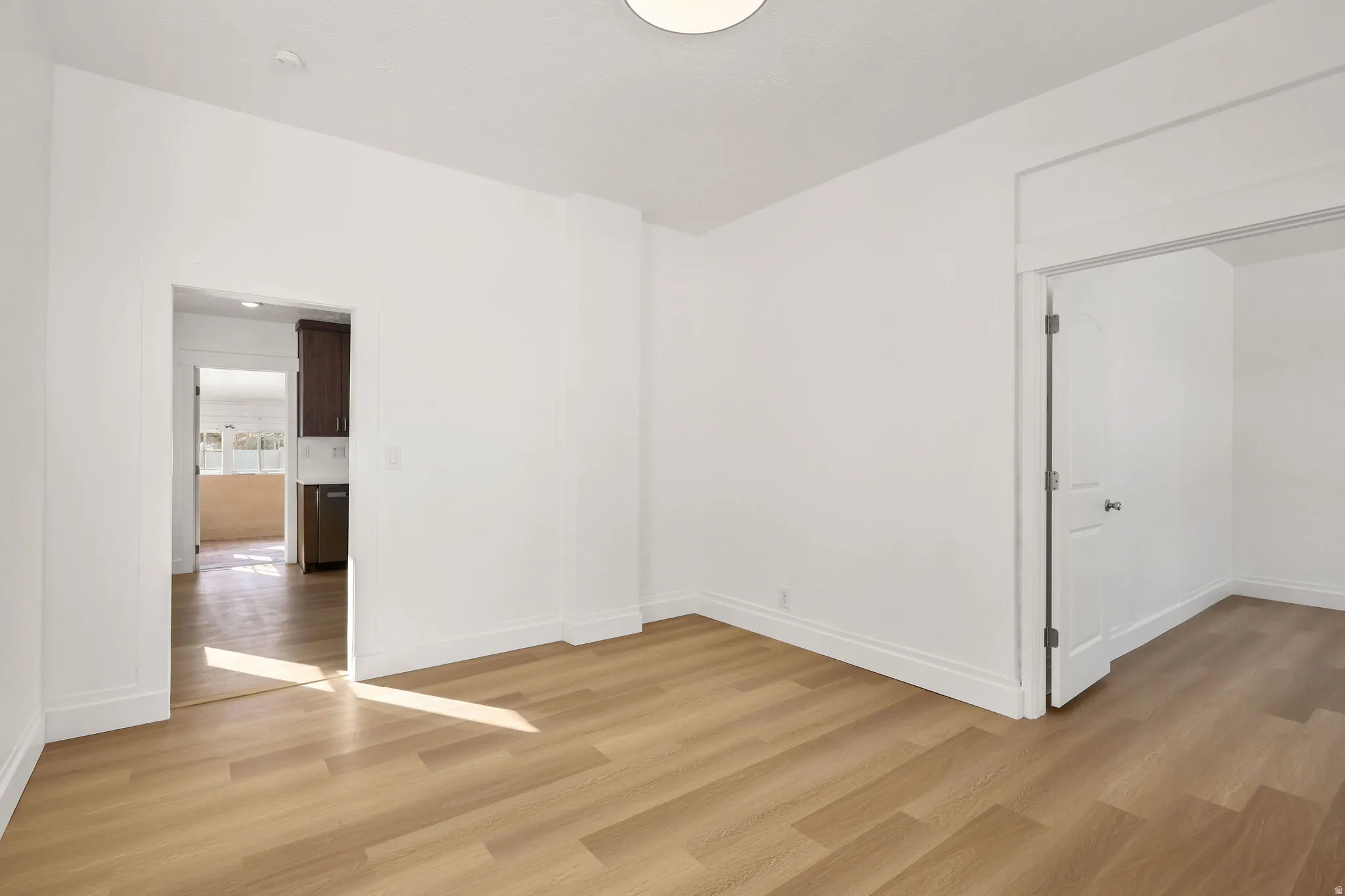 Unfurnished room with light wood-type flooring and baseboards
