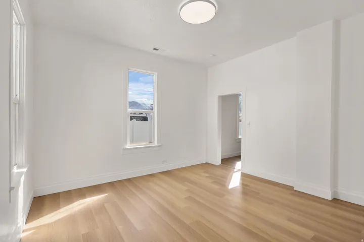 Empty room with baseboards and light wood-type flooring
