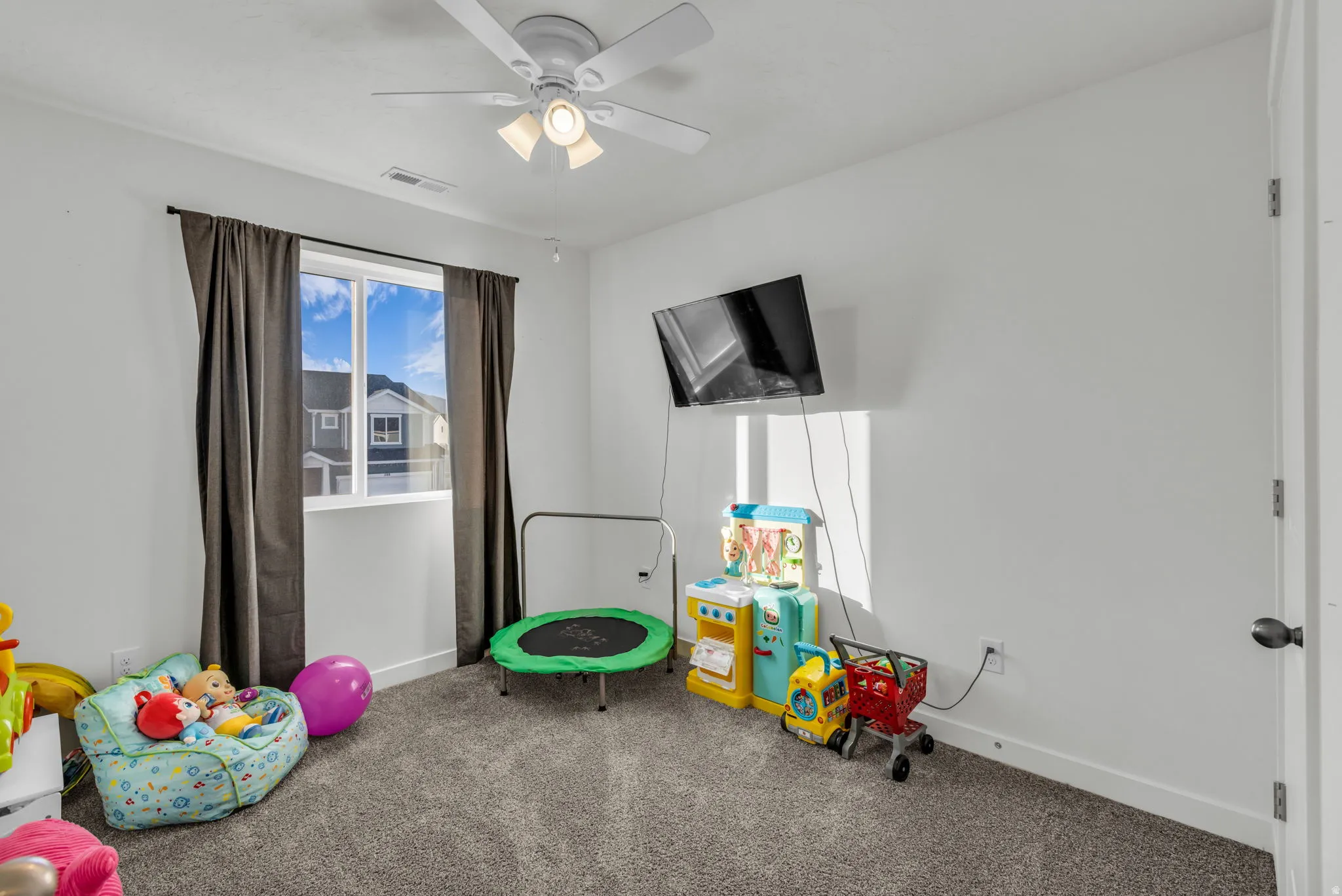 Recreation room with carpet floors and ceiling fan