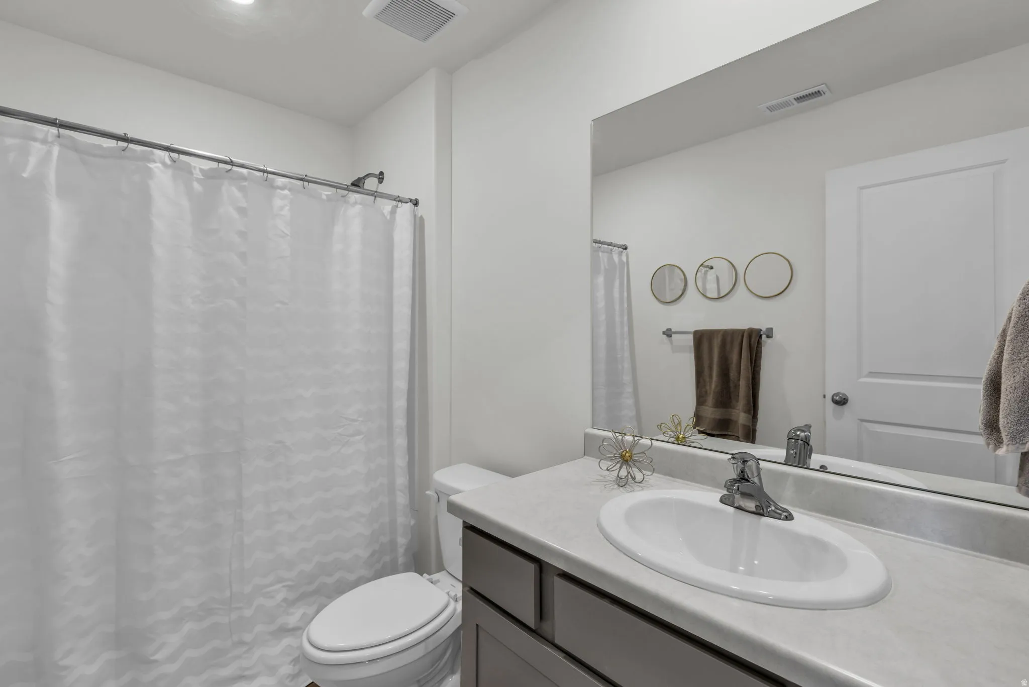 Full bath with vanity and curtained shower