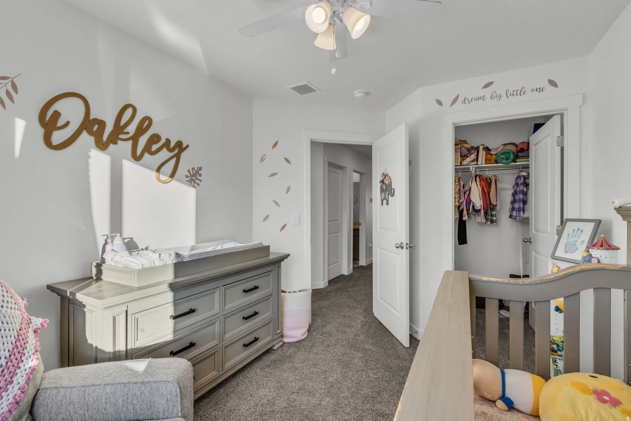 Bedroom featuring dark colored carpet, a closet, and a ceiling fan