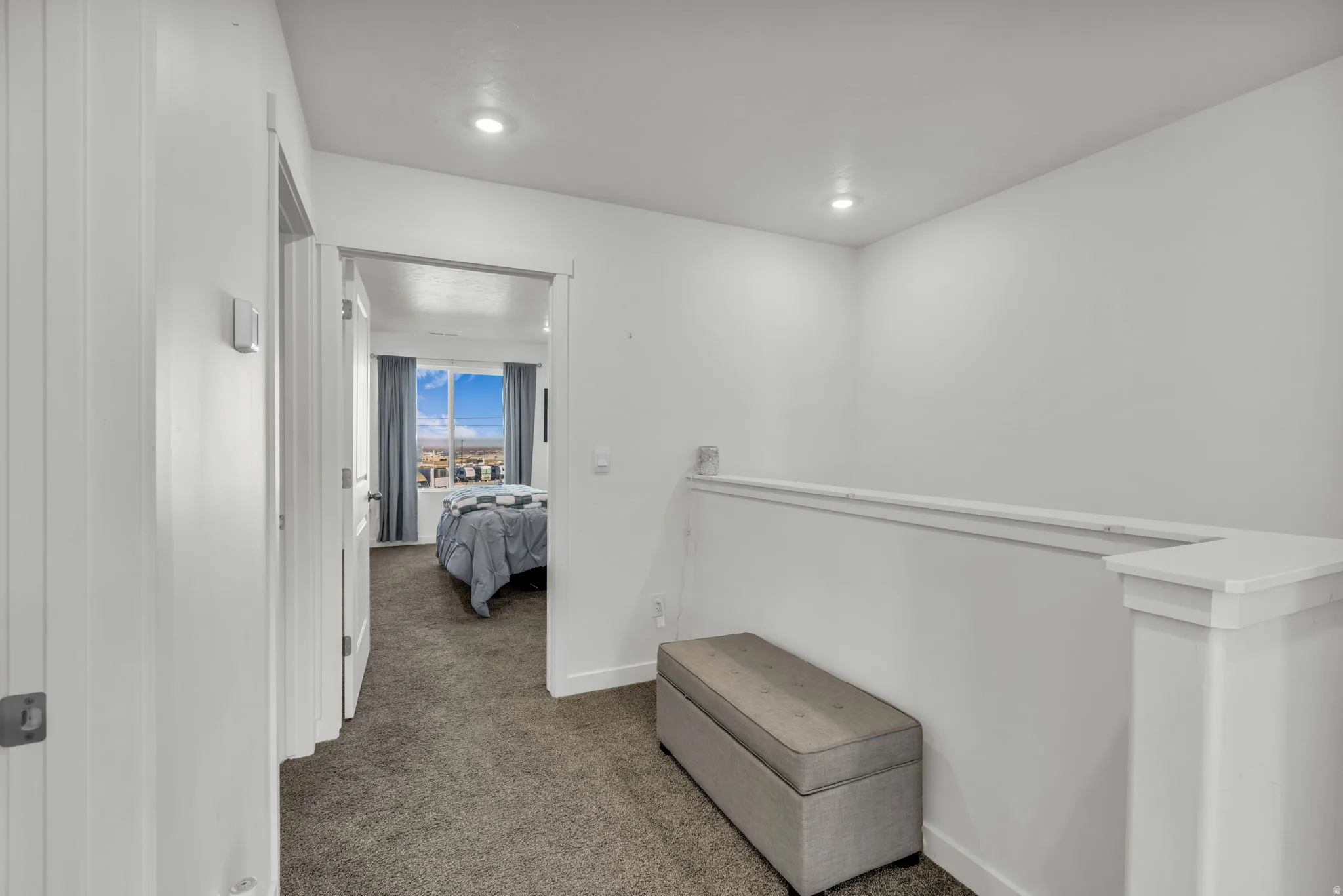 Corridor with carpet flooring and recessed lighting