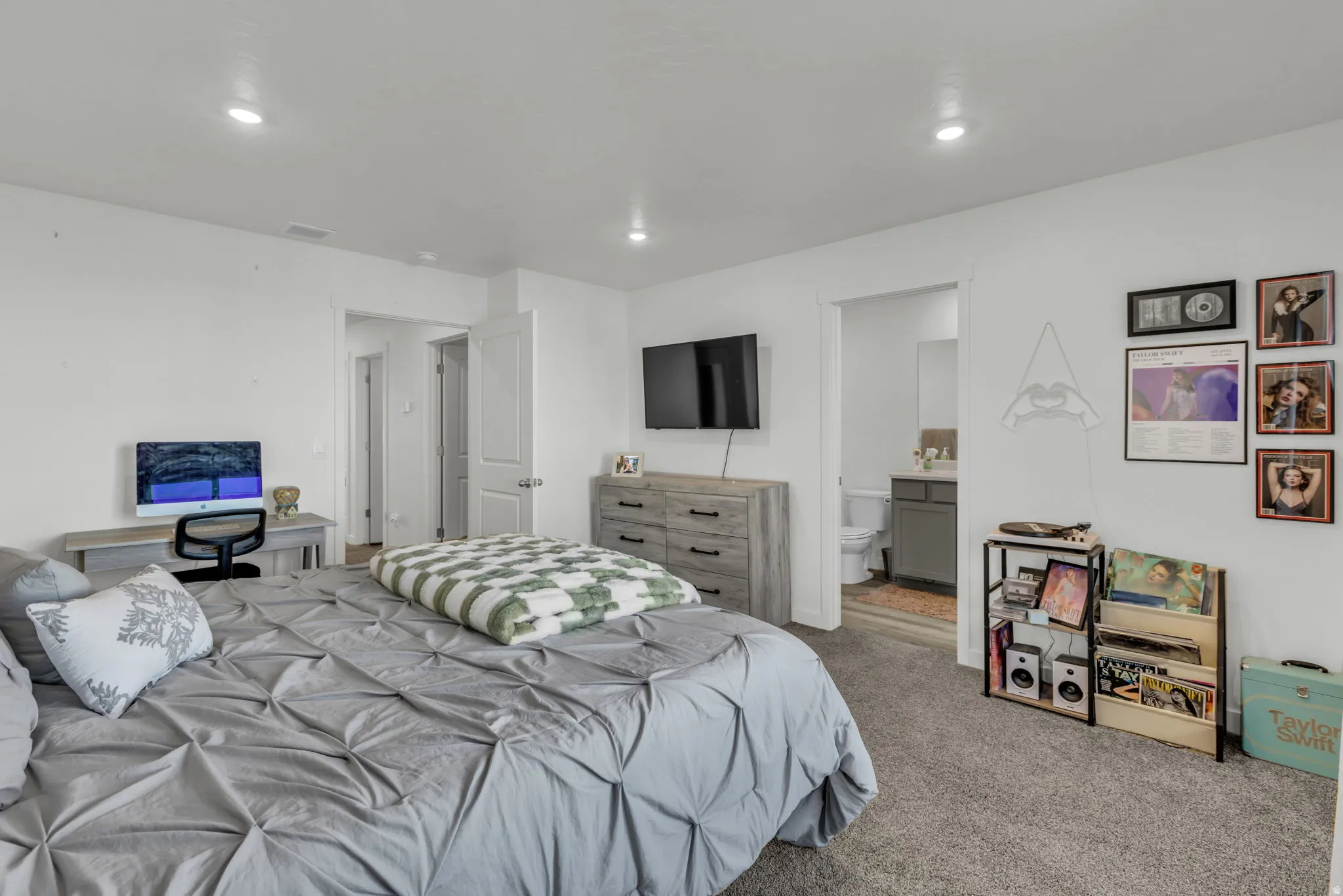 Bedroom with carpet, ensuite bathroom, and recessed lighting