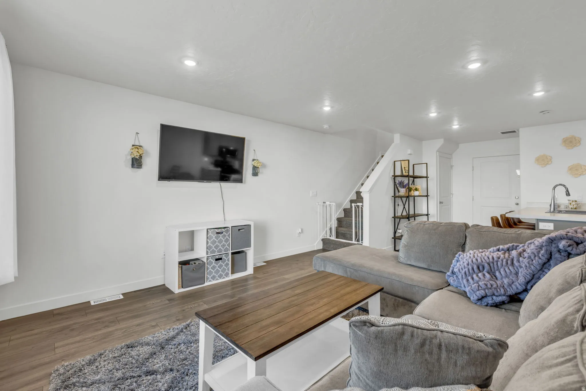 Living room featuring wood finished floors and recessed lighting