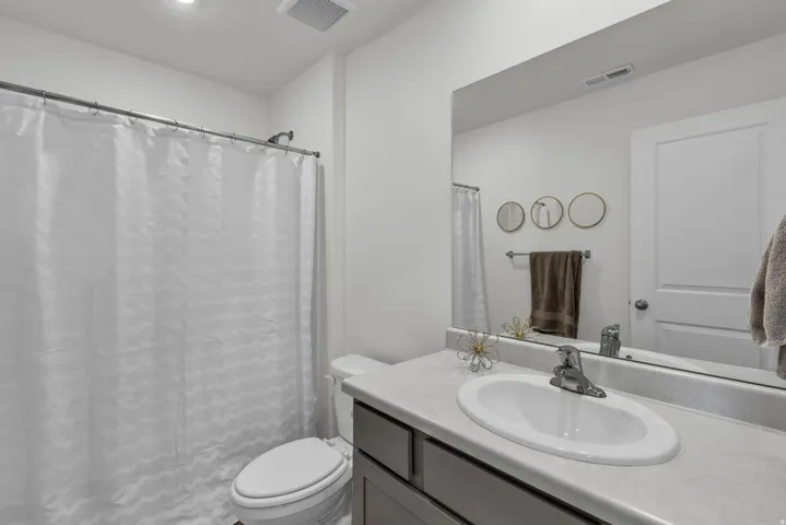 Full bath with vanity and curtained shower